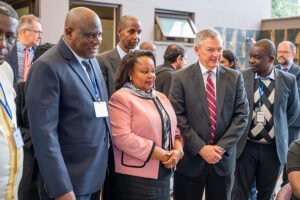 Mercy Wanjau, Secretary to the Cabinet of the Republic of Kenya standing with Kennedy Kaluga