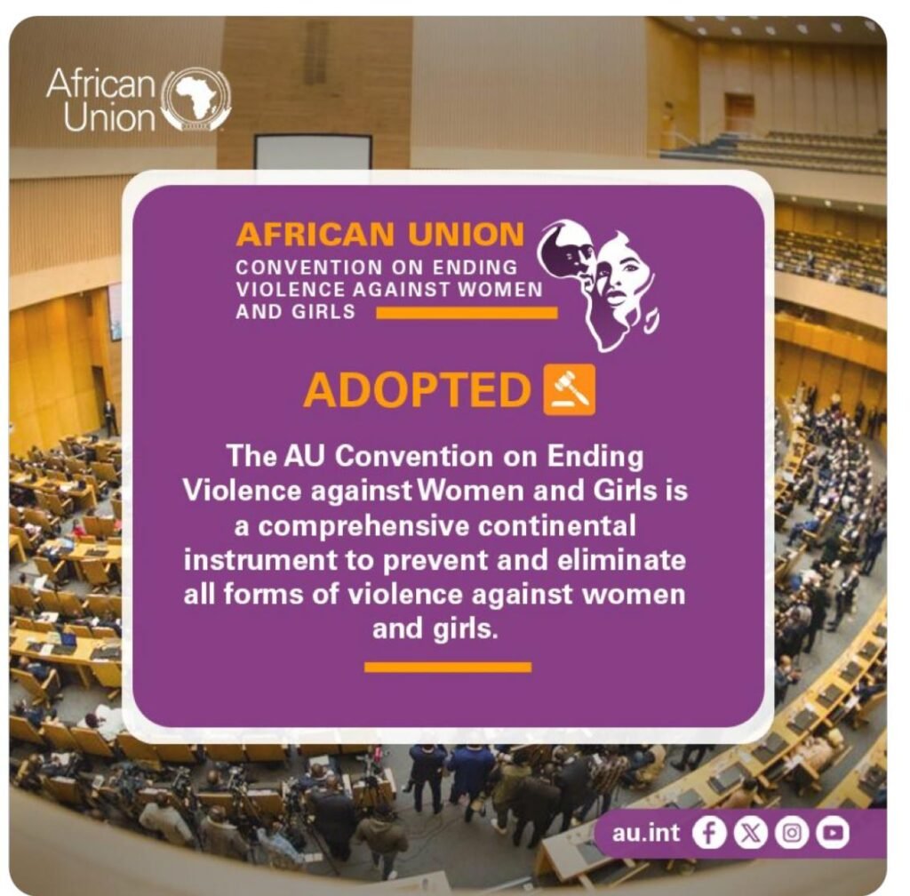 A graphic announcement from the African Union about the adoption of the Convention on Ending Violence Against Women and Girls. The background features a large conference hall filled with delegates. The foreground contains a purple text box with bold yellow and white text stating 'African Union Convention on Ending Violence Against Women and Girls – ADOPTED'. The message describes the convention as a comprehensive continental instrument to prevent and eliminate violence against women and girls. Social media icons and the AU website (au.int) are visible at the bottom.