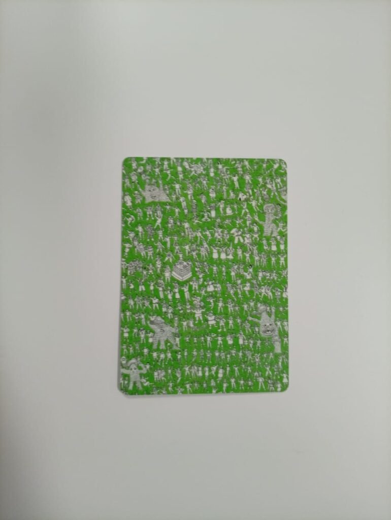 Card used during training depicts a green background filled with small white illustrations of diverse human figures and characters in various poses and activities, forming a dense, repeating pattern across the card.
