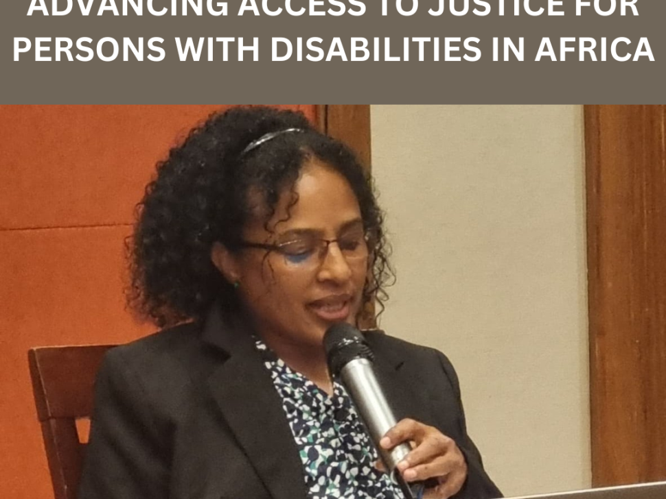 Shitaye Astawes, speaks into a microphone while reading from a laptop. She is seated in front of a wooden panel and cream wall. The image includes a heading at the top in bold white text on a brown background that reads: “ADF'S KEYNOTE ADDRESS ON ADVANCING ACCESS TO JUSTICE FOR PERSONS WITH DISABILITIES IN AFRICA.”||
