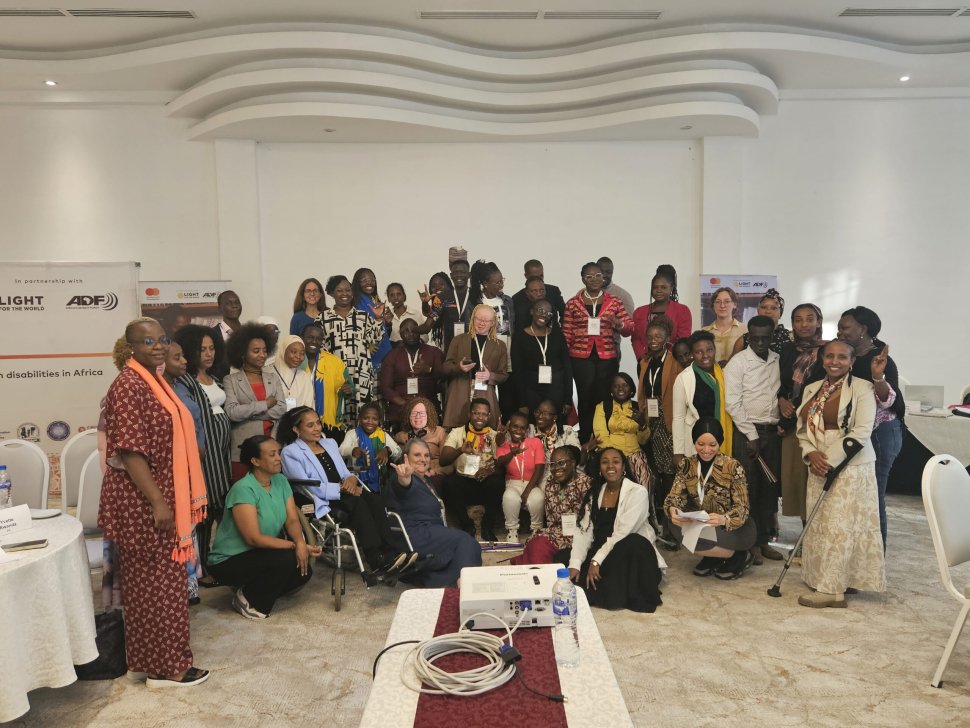 Young leaders with disabilities and facilitators gather joyfully during the Youth Leadership Programme contact workshop in Addis Ababa, smiling, raising hands, and celebrating their shared leadership journey