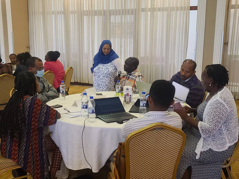 a group of participants sitting around a table working on an activity for the workshop